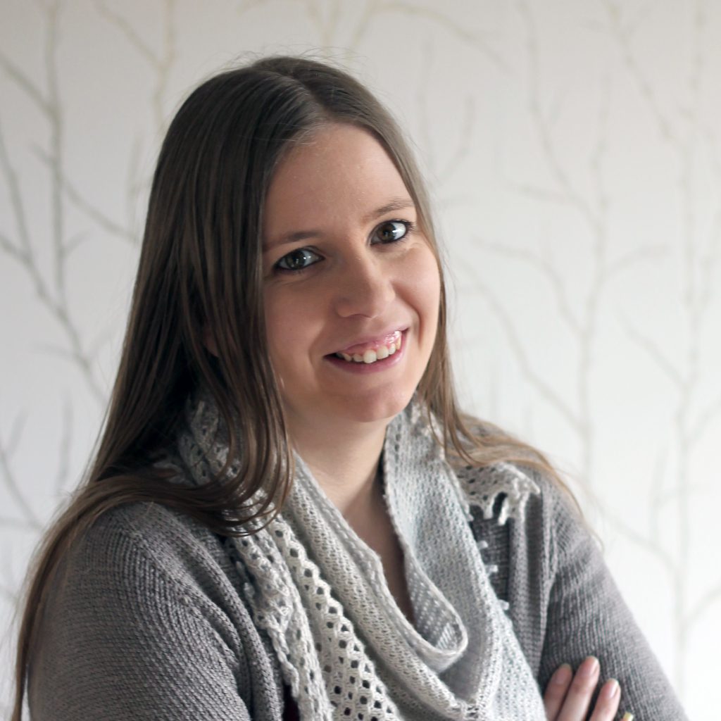 A white woman with brown hair smiling at the camera