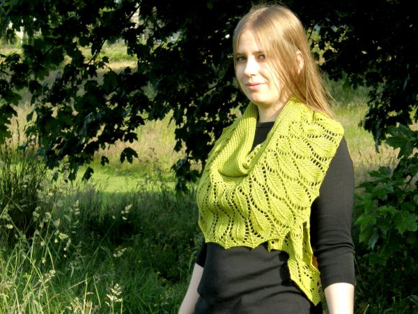 A green shawl with a feather patterned border