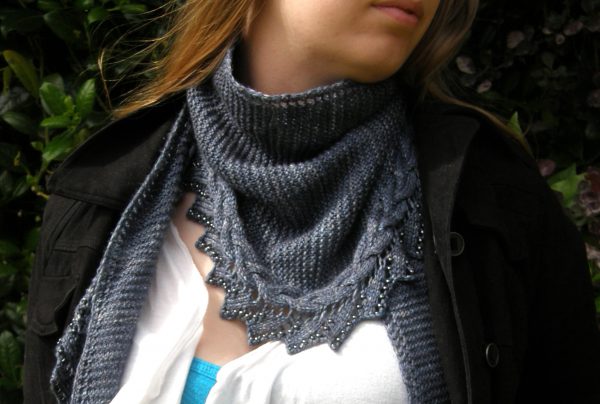 A shawl with a cabled, lace and beaded edge