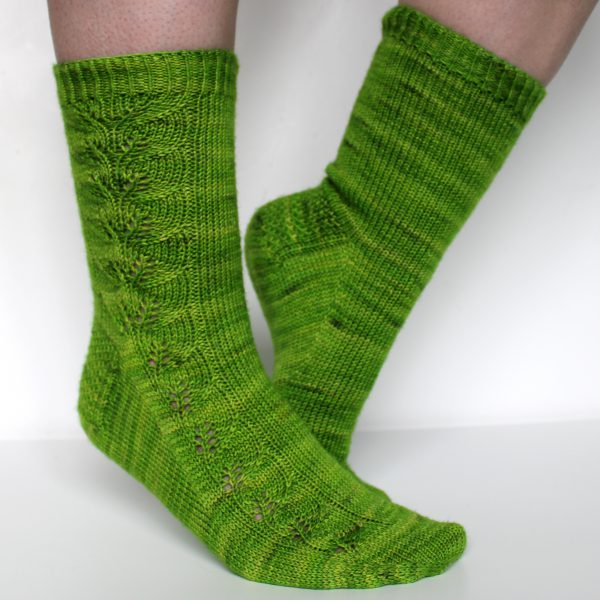 Green socks with a lace leaf pattern up the outside of the foot and leg