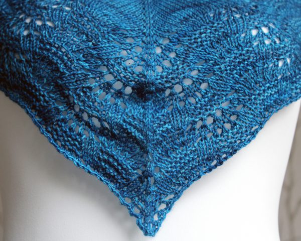 A close up the centre of the cowlette showing the rippling lace and textured border