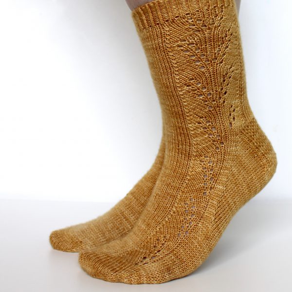 Golden socks with a lace wheat pattern up the outside of the foot and doubling at the leg