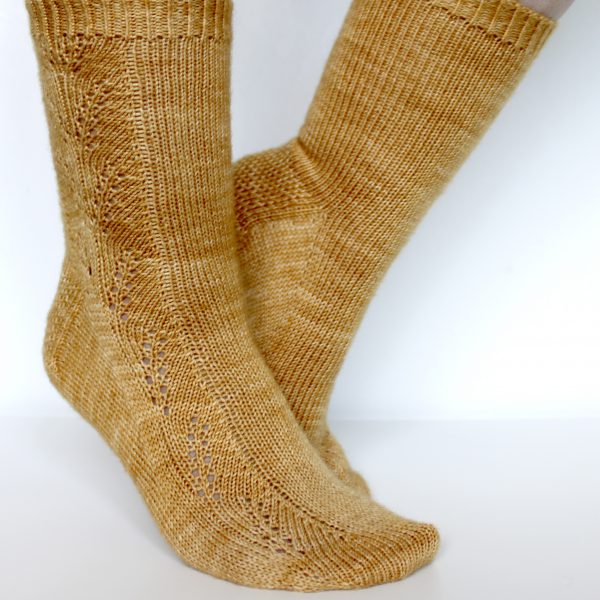 Golden socks with a lace wheat pattern up the outside of the foot and doubling at the leg