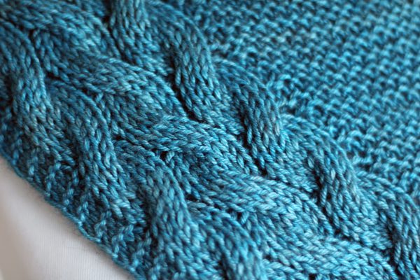 A close up of the cable pattern for Tuinn Bheaga