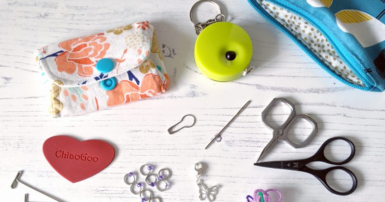 Notions pouches, tape measure, scissors, scrap yarn and a selection of stitch markers