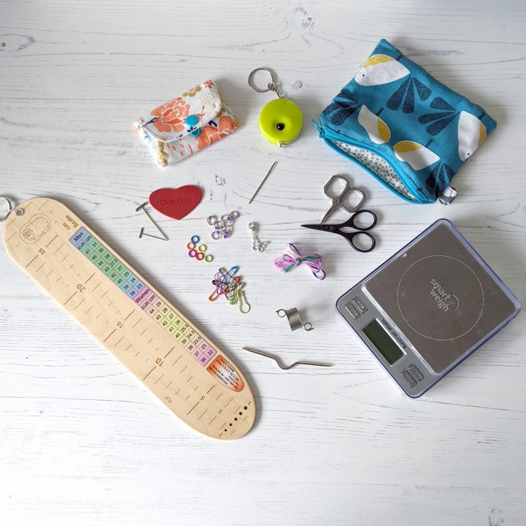 The same items as before, along with a sock ruler, cable needle, knitting thimble and scales