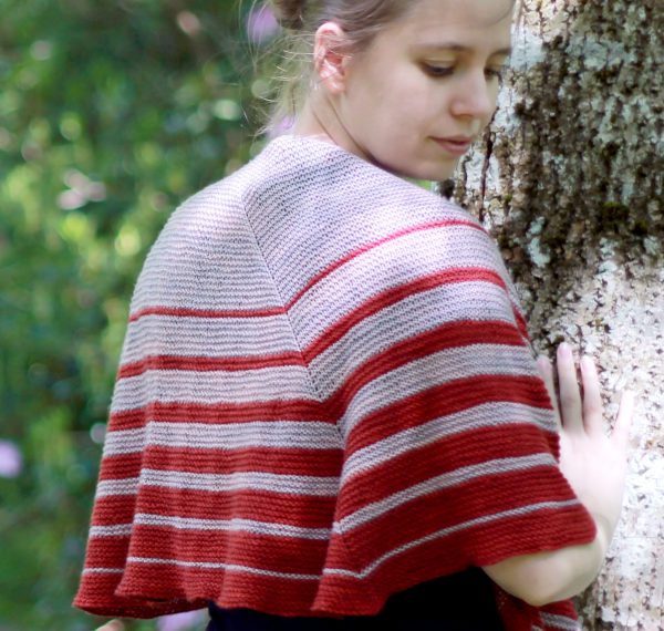 A crescent shaped shawl with graduated strips towards the edge