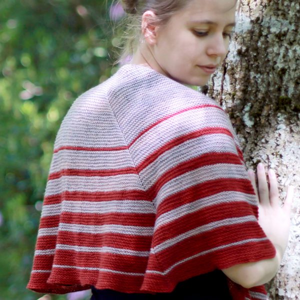 A crescent shaped shawl with graduated strips towards the edge