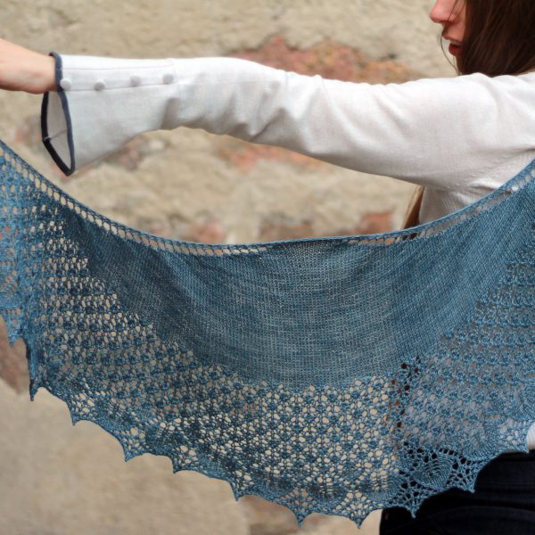A crescent shawl with a stockinette body and wide lace section