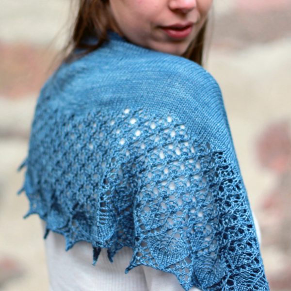 A crescent shawl with a stockinette body and wide lace section