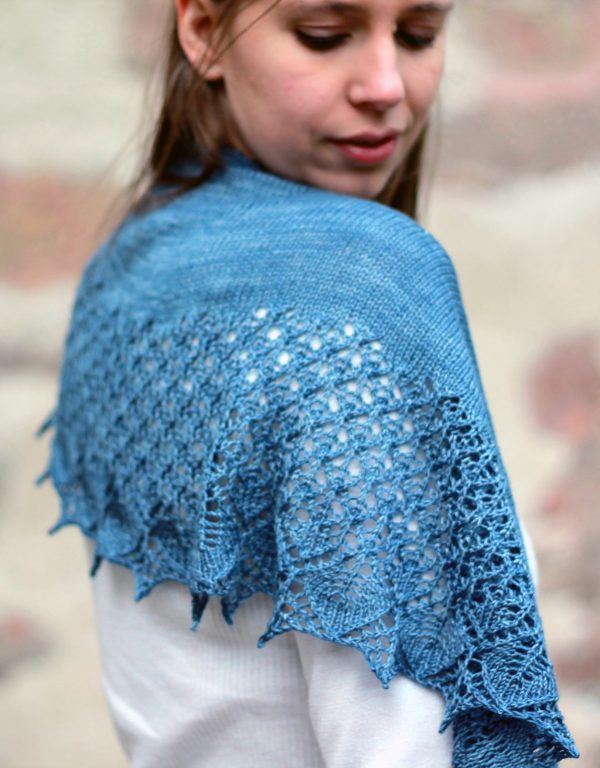 A crescent shawl with a stockinette body and wide lace section