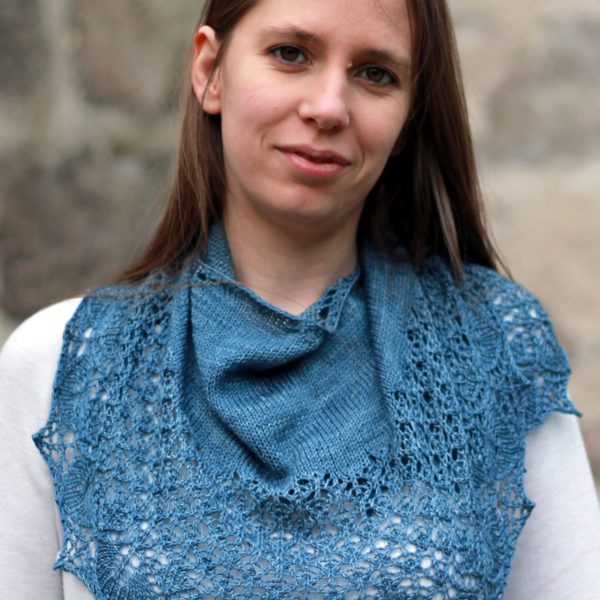 A crescent shawl with a stockinette body and wide lace section