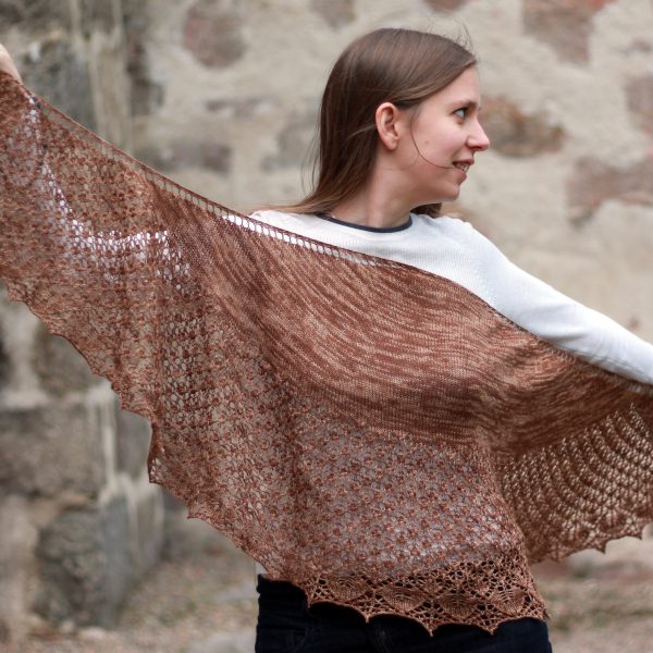A crescent shawl with a stockinette body and wide lace section