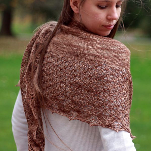 A crescent shawl with a stockinette body and wide lace section