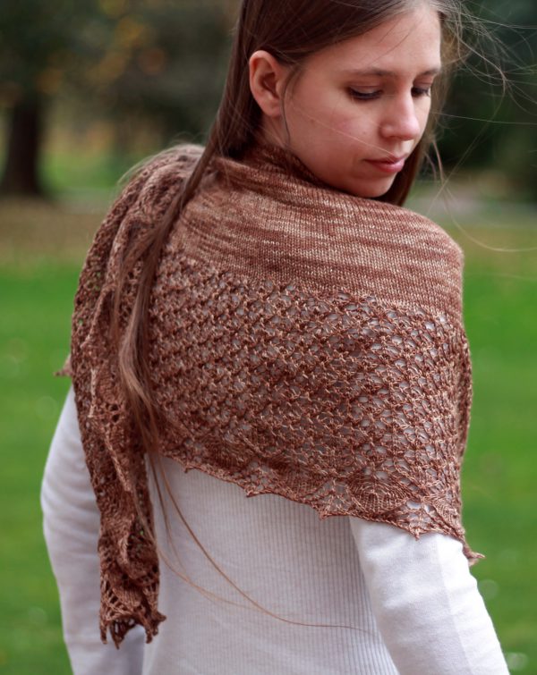 A crescent shawl with a stockinette body and wide lace section