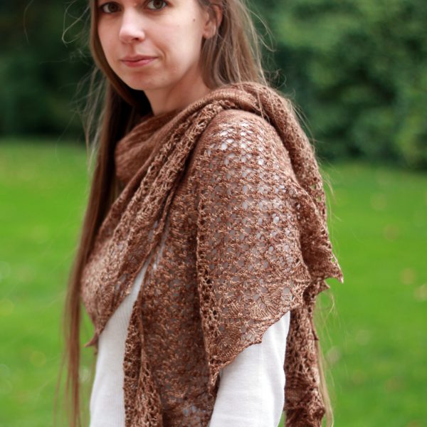 A crescent shawl with a stockinette body and wide lace section