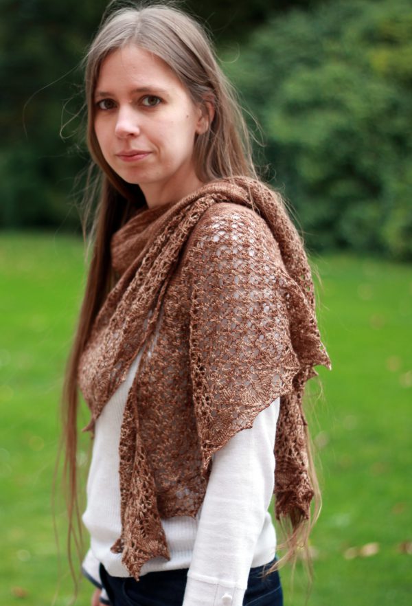 A crescent shawl with a stockinette body and wide lace section