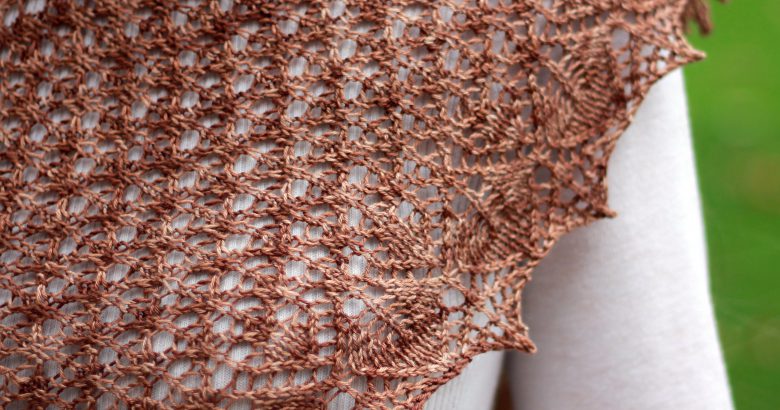 A crescent shawl with a stockinette body and wide lace section