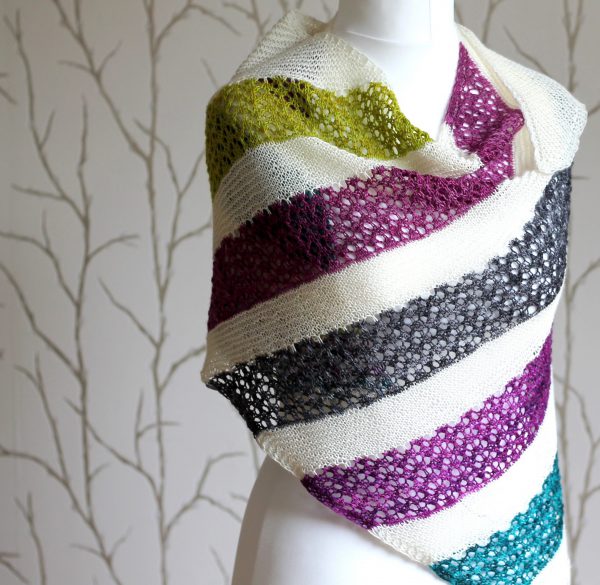 A shawl with coloured lace stripes and chevron border