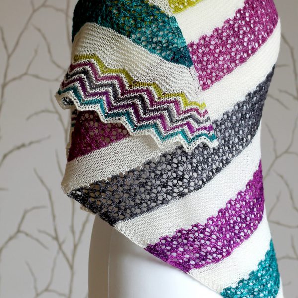 A shawl with coloured lace stripes and chevron border