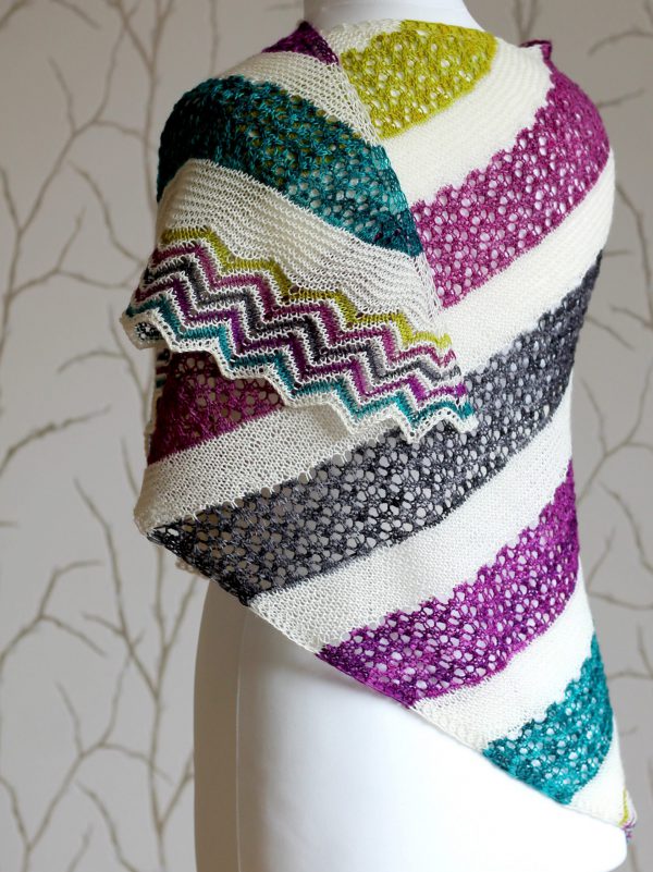 A shawl with coloured lace stripes and chevron border