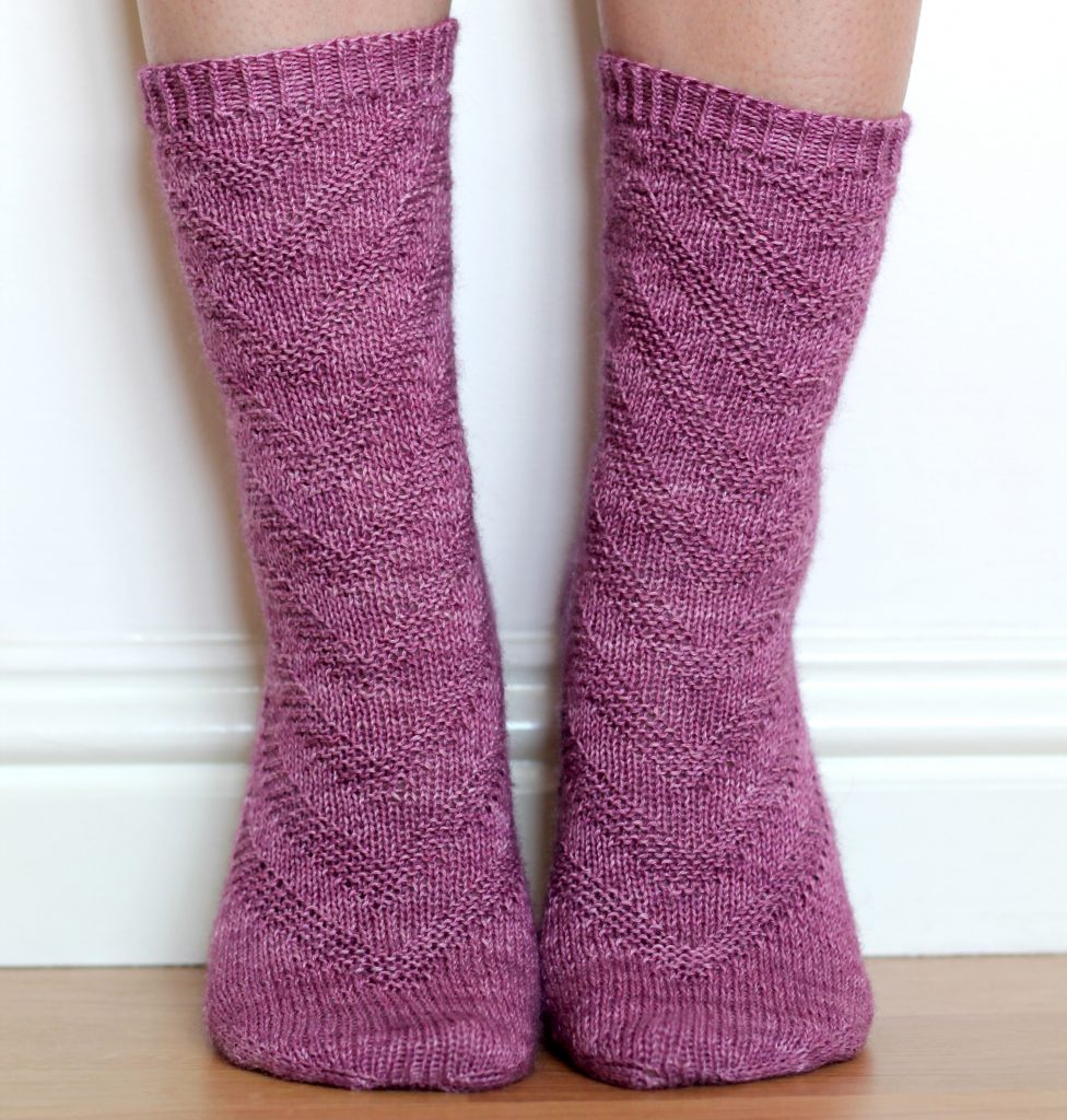 Purple socks with a textured chevron pattern repeated up the sock