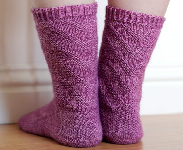 Purple socks with a textured chevron pattern repeated up the sock