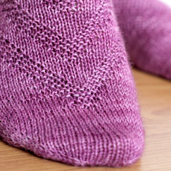 Purple socks with a textured chevron pattern repeated up the sock