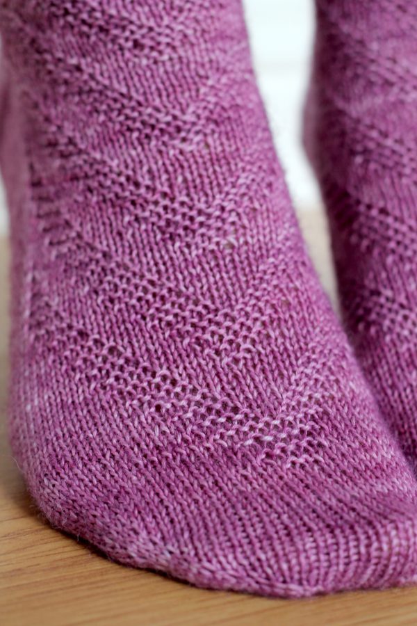 Purple socks with a textured chevron pattern repeated up the sock