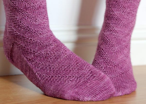 Purple socks with a textured chevron pattern repeated up the sock