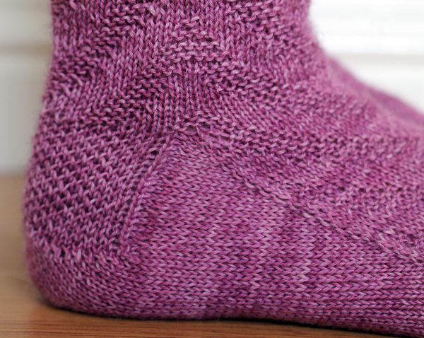 Purple socks with a textured chevron pattern repeated up the sock