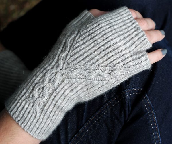 Twisted Rib fingerless mitts with a cable up the centre of the back of the wrist and splitting to either side of the hand