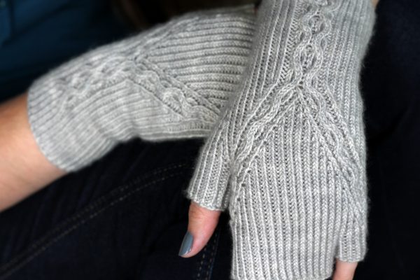 Twisted Rib fingerless mitts with a cable up the centre of the back of the wrist and splitting to either side of the hand