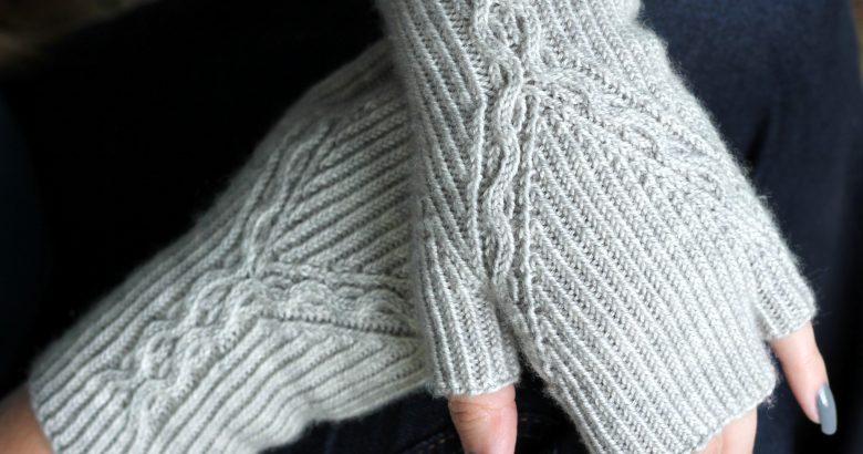 Twisted Rib fingerless mitts with a cable up the centre of the back of the wrist and splitting to either side of the hand