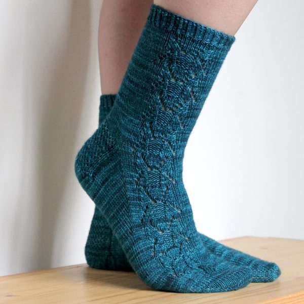 Blue socks with a column of lace up the outside of the foot