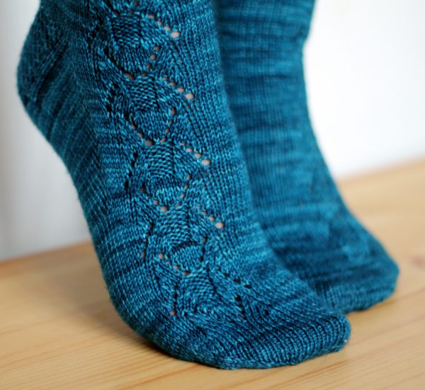 Blue socks with a column of lace up the outside of the foot