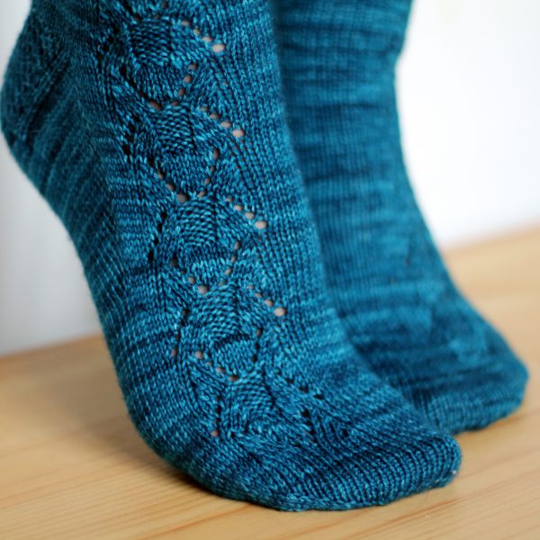 Blue socks with a column of lace up the outside of the foot