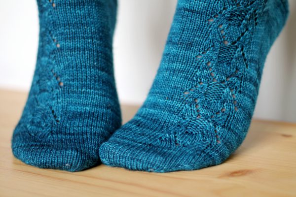 Blue socks with a column of lace up the outside of the foot