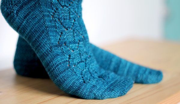 Blue socks with a column of lace up the outside of the foot