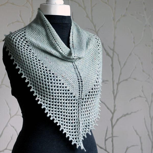 A triangular cowlette with a textured body, wide lace border and picot bind-off