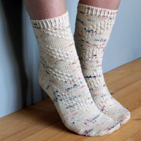 A pair of socks with a textured diagonal stripe mirrored on each foot