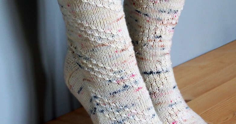 A pair of socks with a textured diagonal stripe mirrored on each foot