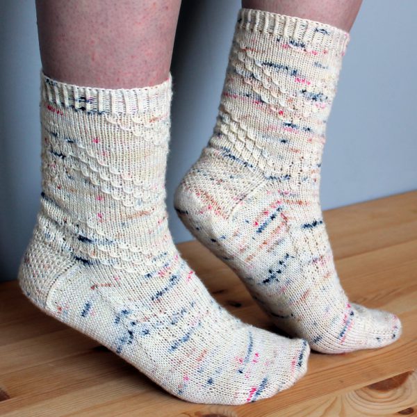 A pair of socks with a textured diagonal stripe mirrored on each foot