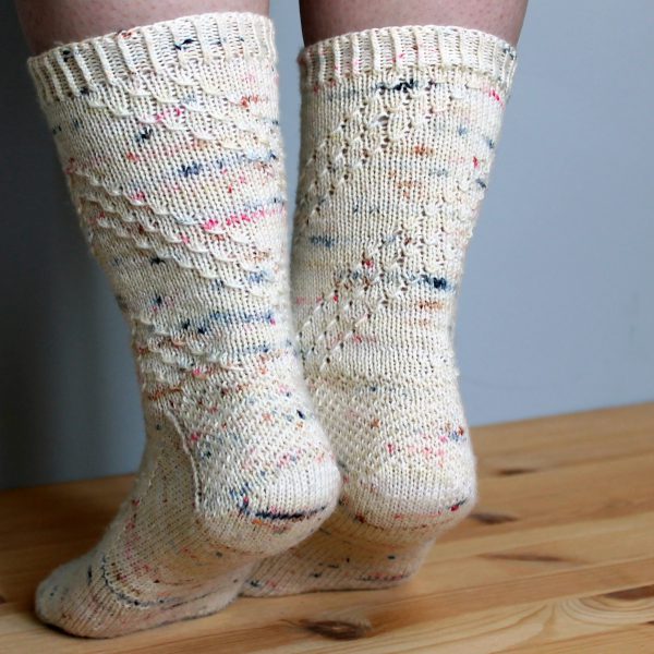 A pair of socks with a textured diagonal stripe mirrored on each foot