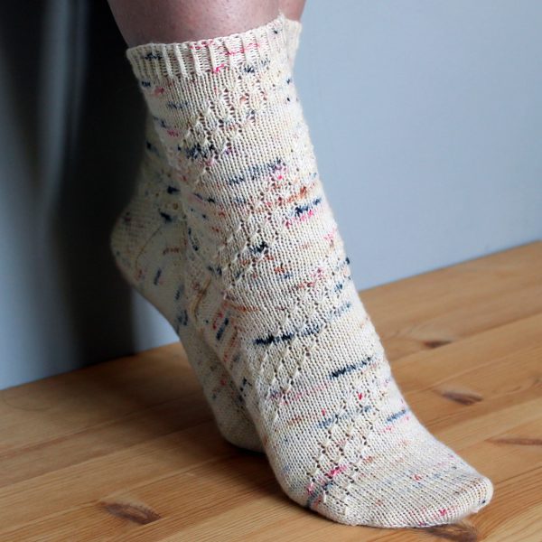 A pair of socks with a textured diagonal stripe mirrored on each foot