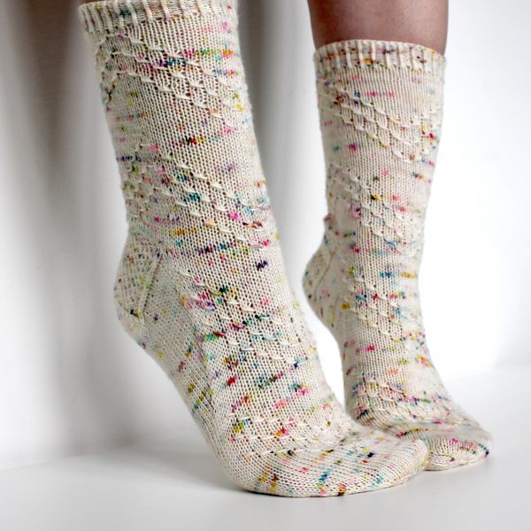 A speckled pair of socks with a textured chevron pattern