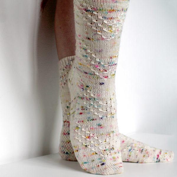 A speckled pair of socks with a textured chevron pattern