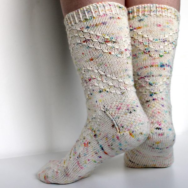 A speckled pair of socks with a textured chevron pattern