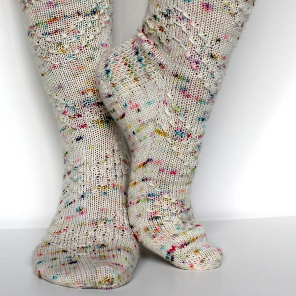 A speckled pair of socks with a textured chevron pattern