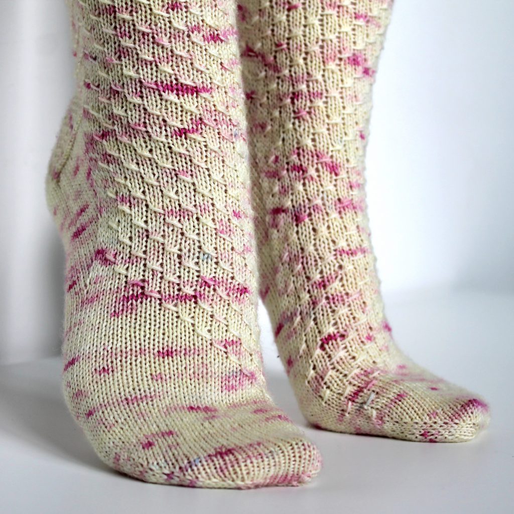 Speckled socks with a wide diagonal stripe with a textured pattern mirrored across each foot